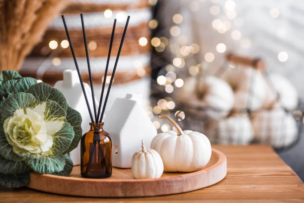 istock Aroma diffuser. Autumn scented perfumes for the home in a glass bottle with sticks as an air freshener in the house and pumpkins. Aromatherapy, cozy atmosphere, comfort and relaxation. 2183714606