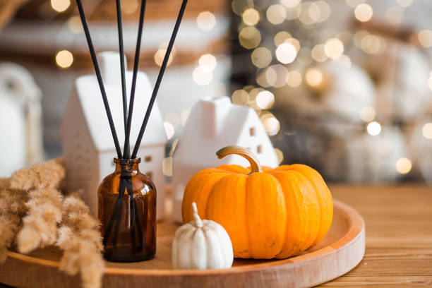 istock Aroma diffuser. Autumn scented perfumes for the home in a glass bottle with sticks as an air freshener in the house and pumpkins. Aromatherapy, cozy atmosphere, comfort and relaxation. 2183714617
