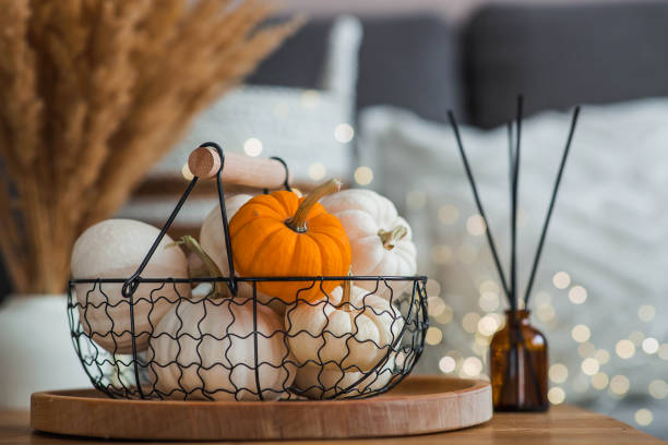 istock Aroma diffuser. Autumn scented perfumes for the home in a glass bottle with sticks as an air freshener in the house and pumpkins. Aromatherapy, cozy atmosphere, comfort and relaxation. 2183714623