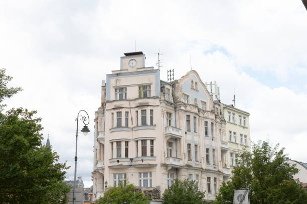 istock A big building with a clock is surrounded by trees and a lamp 2183715018