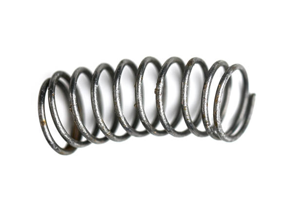 Close-up of used old metal spring on white background, top view