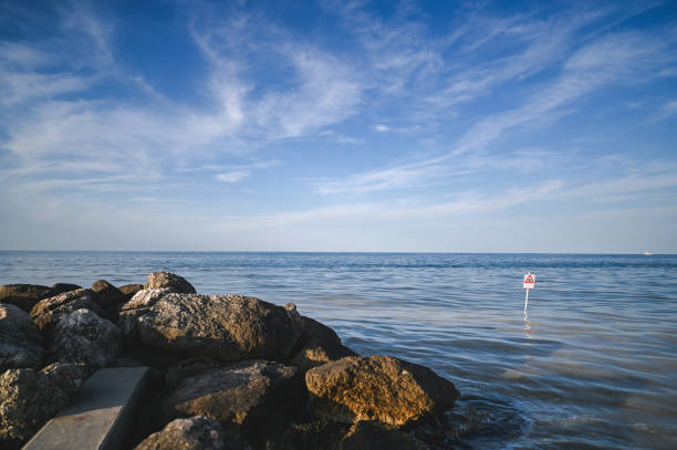 cliff with calm sea water.