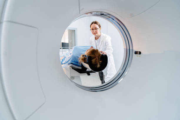 istock Doctor assists patient undergoing tomography scan with care 2183717598