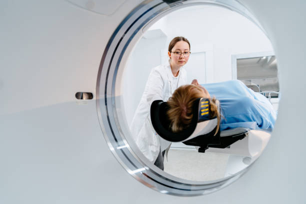 istock Doctor preparing patient for a medical scan inside tomography machine 2183717602