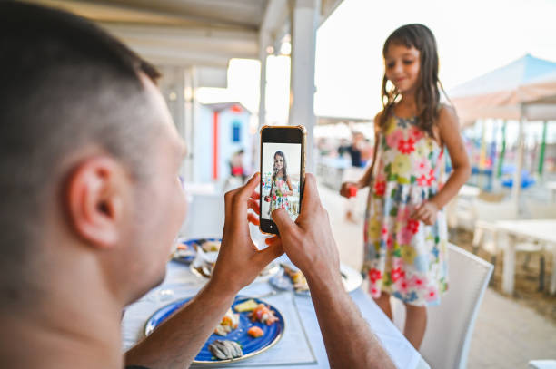 istock Father taking a photo of daughter. 2183717646