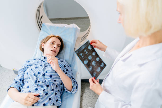 istock Middle-aged Caucasian woman lying on MRI machine bed during scan. 2183717721