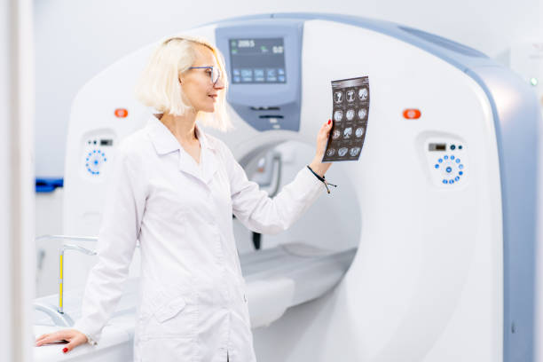 istock Blond woman stands confidently by MRI machine 2183717741