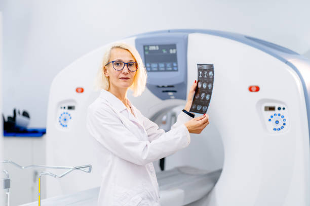 istock Blond woman stands confidently by MRI machine 2183717751