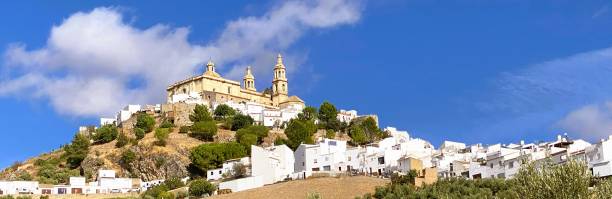 Olvera is a charming town in Cádiz, Andalusia, known for its stunning whitewashed buildings and dramatic cliffs.  As part of the “Pueblos Blancos” (White Towns) route, Olvera showcases the distinctive architecture typical of this picturesque region. This phot was taken on September 28 2024 near Olivera, Andalusia, Spain.