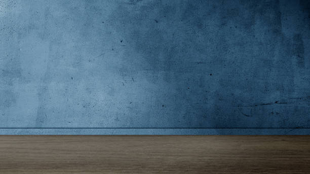 grungy, aged blue concrete wall with a horizontal line separating it from a dark wooden floor. perfect for interior. room backdrop for products displayed. empty blue room with walnut wood floor. muro de hormigón azul envejecido y sucio con una línea horizontal que lo separa de un suelo de madera oscura. perfecto para interior. telón de fondo de la sala para los productos expuestos. habitación azul vacía con suelo de madera de nogal.
