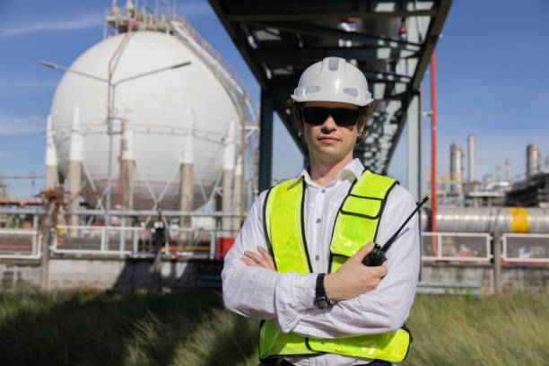 istock Engineer using a walkie talkie at the oil refinery site 2183721820