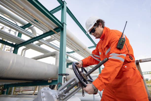 istock Engineer turning a hand wheel valve at the oil refinery site 2183721831