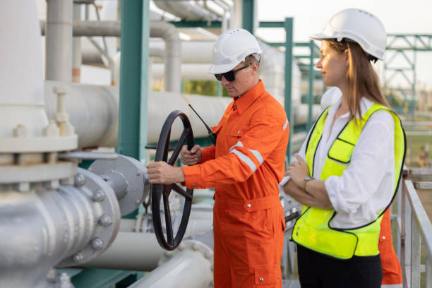 istock Engineer turning the hand wheel valve at the oil refinery site 2183721833
