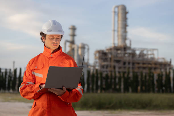istock Engineer with laptop working at the oil refinery site 2183721858