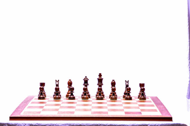The chess board and arranged pieces on the dark background