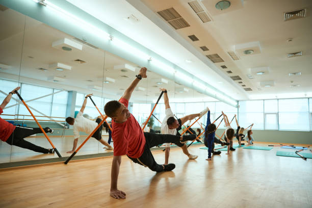 istock Sporty people doing exercises with training equipment over mirror wall 2183730277