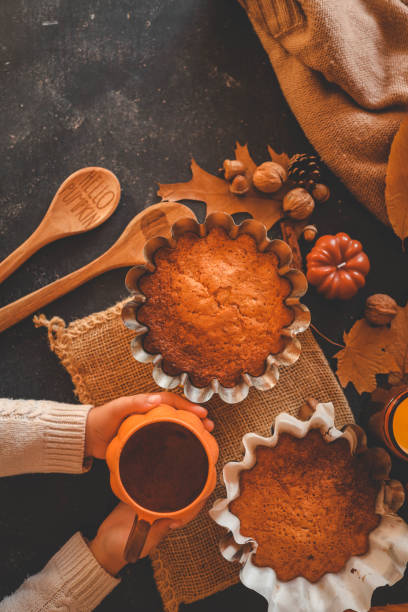 istock Cup of tea in hands and pumpkin pie, cozy autumn 2183730848