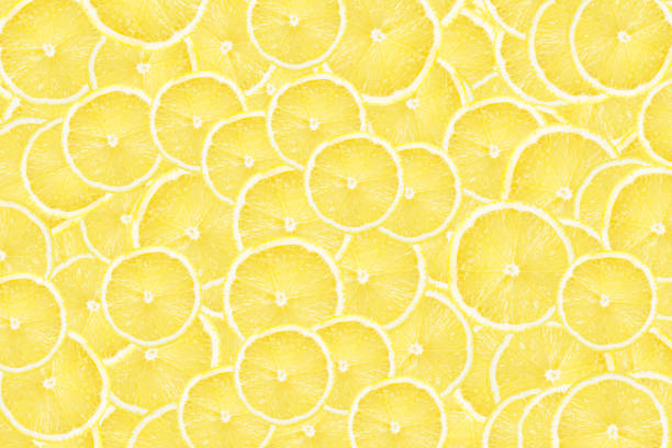 istock Lemon slices background.Vibrant yellow color. Citrus fruit cut texture with refreshing section pattern. Summer design and bright, cheerful decorations. Culinary and beverage backdrop. 2183730927