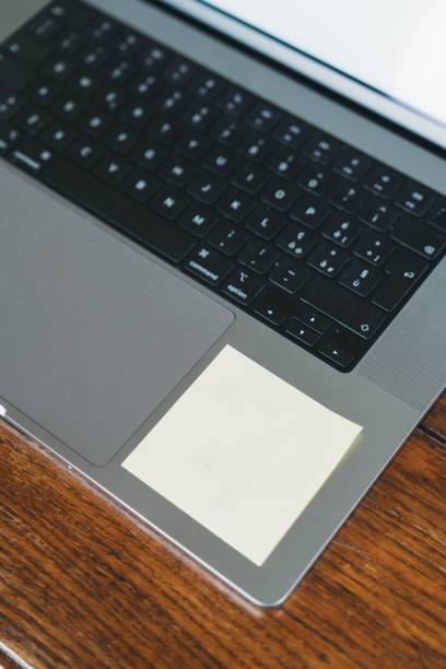 istock Blank sticky note on modern laptop keyboard on wooden desk 2183733131