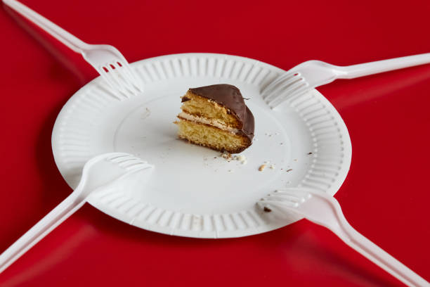 Top-quality cheesecake being sliced by a fork. Served with sweet red sauce.
