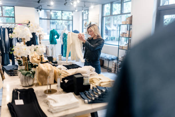 istock Boutique Store Owner Hard at Work Arranging Product 2183734122