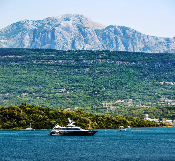 Luxury yacht in Adriatic sea, Montenegro. Touristic boat with view on scenic mountains and forest