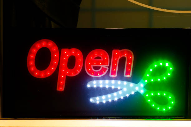 Open sign with scissors at hair salon