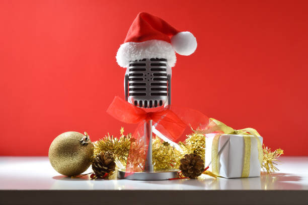 istock Retro microphone with Santa hat on white table with gifts 2183735440
