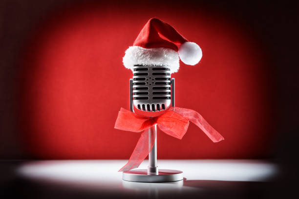 istock Christmas retro microphone for performance with spotlight illuminating decorated 2183735450