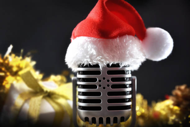 istock Retro microphone with christmas decoration on black background 2183735456