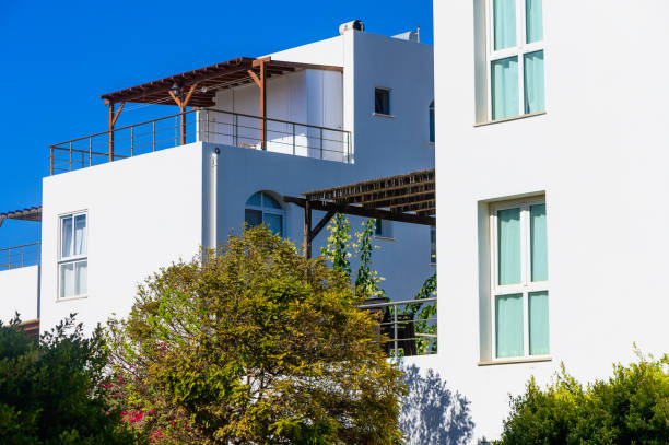 istock Bright summer day illuminating modern white architecture with lush greenery in a serene setting 2183738066