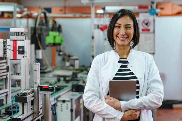 istock Smiling Mid Adult Female Robotic Engineer with Tablet in Laboratory 2183739305