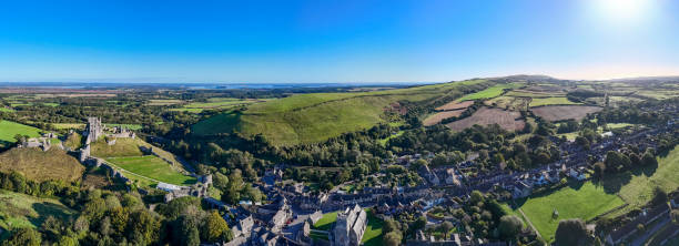 Drone shot of the ruins of Corfe Castle, on a hill. Corfe Castle, Dorset, UK
