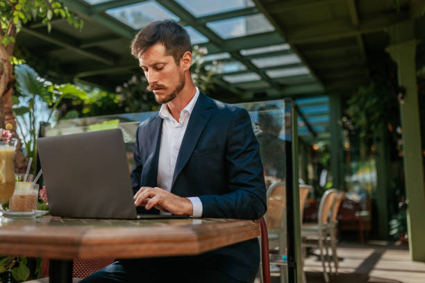 istock Businessman working on his laptop in a cafe 2183741364