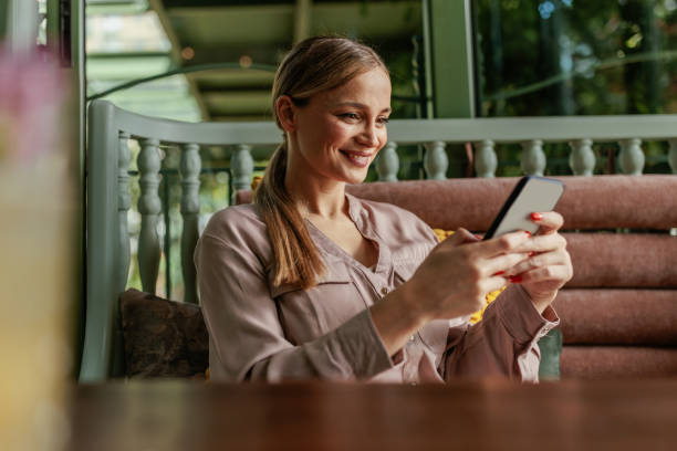 istock Woman scrolling on her phone while sitting in a cozy cafe 2183741384