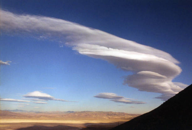 Windblown saucer shaped lenticular clouds above Owens Valley give an eerie allusion as seen from the Sierra Nevada Mountains.