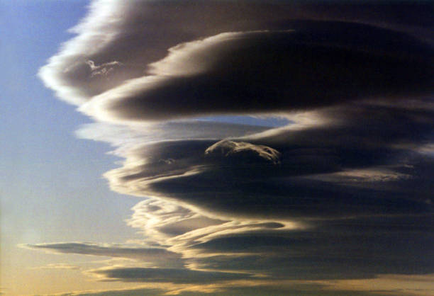 Collection of lenticular clouds brace against the winds as viewed in the Sierra Nevada Mountains.