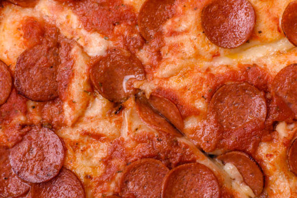 istock Pepperoni pizza with sausage, mozzarella cheese, tomatoes, salt and spices 2183744118