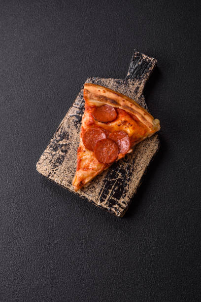 istock Pepperoni pizza with sausage, mozzarella cheese, tomatoes, salt and spices 2183744161