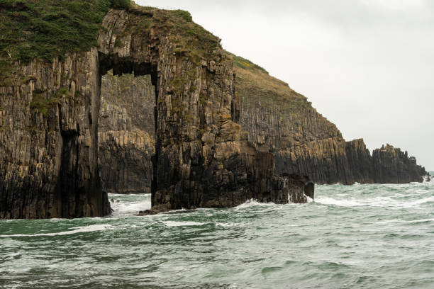 Stunning flysch cliffs rising from the ocean in cloudy day, basque country, spain