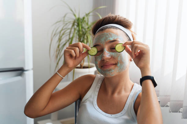 istock Face masked woman in relaxing pose with cucumbers 2183745566
