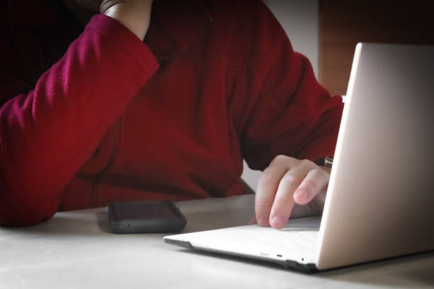 istock close-up of man working at a laptop computer at a white table business education technology image 2183745690