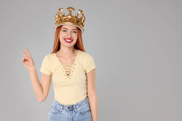 istock Beautiful young woman with inflatable crown on light grey background, space for text 2183746771