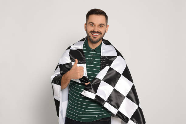 istock Man with checkered flag showing thumb up on white background 2183748446