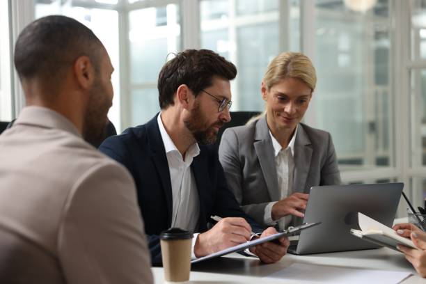 istock Lawyers working together at table in office 2183752645