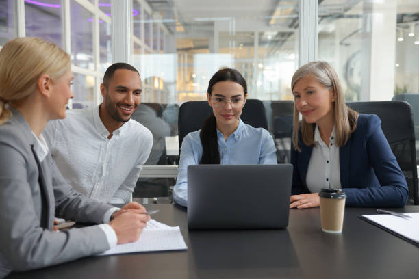 istock Lawyers working together with laptop at table in office 2183752685