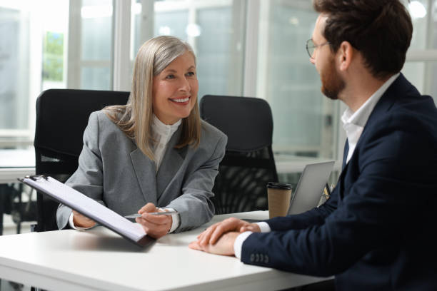 istock Lawyer with clipboard working with client at table in office 2183752690