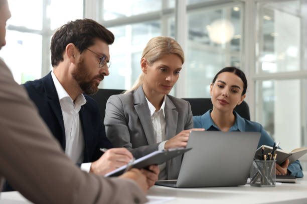 istock Lawyers working together with laptop at table in office 2183752813