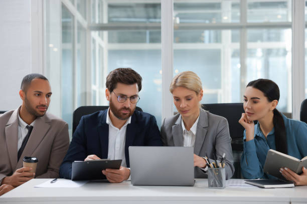 istock Lawyers working together with laptop at table in office 2183752834