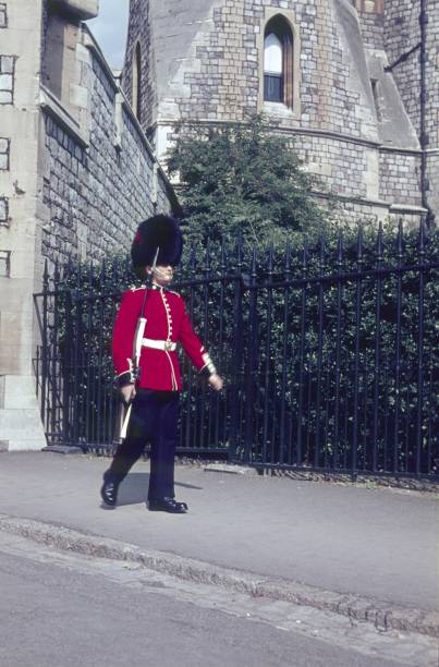 British guards in bearskin hats and red uniforms on parade in London, UK. Changing the guard takes place several times each week and is a very popular tourist destination